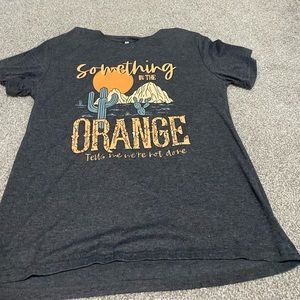 something in the orange tee